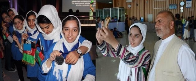 Afghan teenager Fatemah Qaderyan takes a photograph with her father at Herat International Airport on July 13.