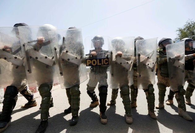 Afghan civil order policemen take position as Afghanistan's Hazara minority attend a protest in Kabul, Afghanistan July 23, 2016.