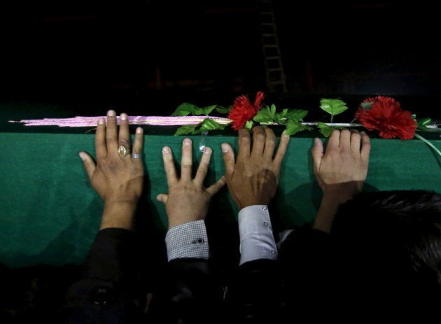 Men carry one of the coffins for the seven people who were killed by unknown militants, during a protest procession in Kabul, Afghanistan Nov. 10, 2015. A protest convoy drove the bodies of seven members of Afghanistan's minority Hazara community to the capital Kabul to protest against their murder by unknown militants, who dumped their partially beheaded bodies at the weekend.