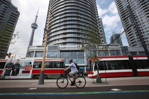 A cyclist uses the newly opened bike lanes on Queens Quay between Yonge and Bathurst on June 18, 2015.