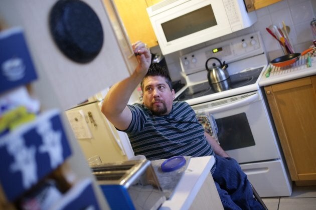 Teaching assistant Ryan Leoworthy rolls around his kitchen at his Mississauga condo on December 18, 2015. Leoworthy suffers from Spinal Bifida, limiting his mobility and the constant strain on his upper body makes it incredibly difficult to go about his daily life.