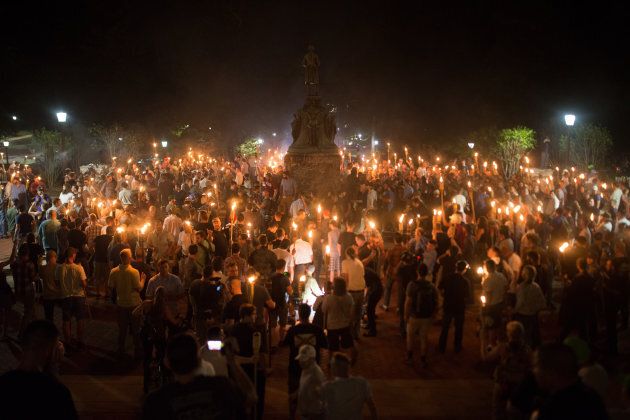White Supremacists encircle counter protestors at the base of a statue of Thomas Jefferson after marching through the University of Virginia campus with torches in Charlottesville, Va., USA on August 11, 2017.