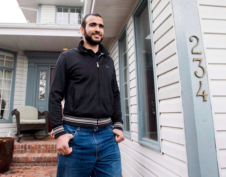Omar Khadr walks out the front door of his lawyer Dennis Edney's home to speak the media in Edmonton, Alta. on Thursday, May 7, 2015.