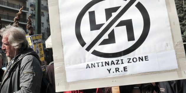 Anti-racist and anti-nazi activists gather outside the appeals court in Athens during the appearance of Greece's extreme right Golden Dawn party parliament member, Ilias Kasidiaris in Athens on March 4, 2013. (LOUISA GOULIAMAKI/AFP/Getty Images)