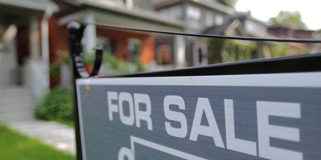 A sign advertises a house for sale on a residential street in Toronto on July 12, 2017.