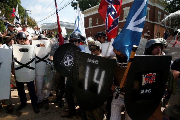 White supremacists stand behind their shields at a rally in Charlottesville, Virginia, U.S., Aug. 12, 2017.