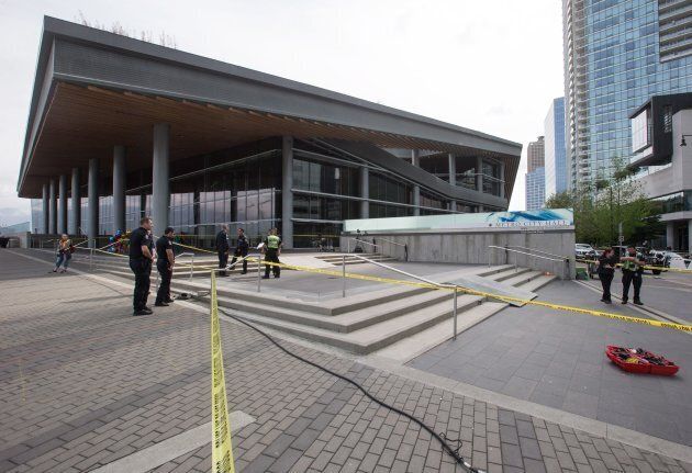 Ramps for a motorcycle stunt are seen on the steps outside the Vancouver Convention Centre while police officers investigate after a stunt driver working on the movie "Deadpool 2" died after a crash on set in Vancouver on Aug. 14, 2017.