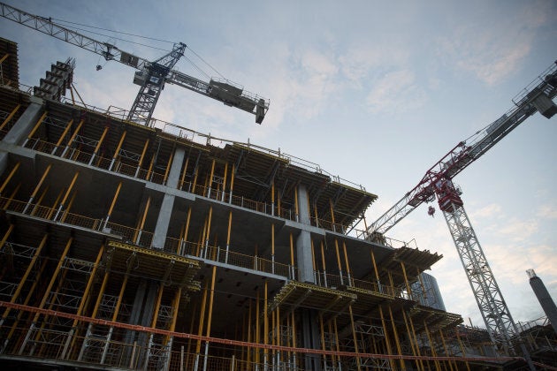 Cranes operate at a condominium under construction in Toronto, Ont., on Saturday, May 27, 2017.