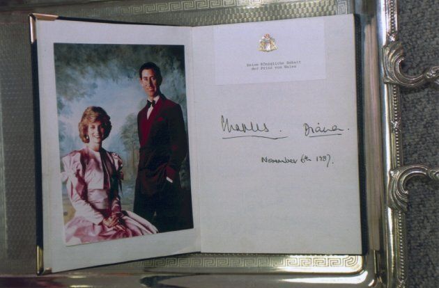 Senatsbarkasse guestbook with the signatures of Prince Charles and Princess Diana from June 11, 1987, as well as an official photo of the couple. (Frederika Hoffmann/ullstein bild via Getty Images)