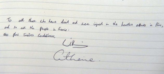 The message written by Britain's Prince William, Duke of Cambridge and also signed by Catherine, Duchess of Cambridge is seen in the book of condolences at the French embassy in London following last week's attacks in Paris on November 17, 2015. (NIKLAS HALLE'N/AFP/Getty Images)