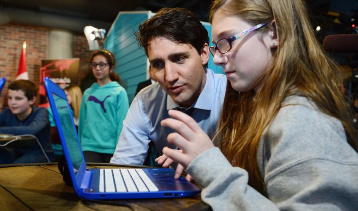 Prime Minister Justin Trudeau talks with grade 7 student Isabel Clement, 12, of D.A. Aubrey Intermediate as they take part in an Hour of Code event at Shopify in Ottawa, Ont. on Monday, Dec. 5, 2016.
