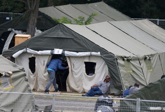 A group of asylum seekers wait in their tent encampment in Lacolle, Que., Aug. 11, 2017.