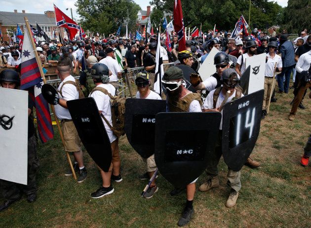 Members of white nationalist protesters hold shields as they clash against a group of counter-protesters in Charlottesville, Virginia, U.S., Aug. 12, 2017.