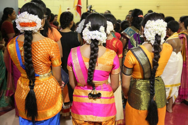 Tamil Hindu children listen to prayers after performing a Bharatnatyam dance during the Nambiyaandaar Nambi Ustavam Thiruvizha pooja at a Hindu Temple in Ontario on July 19, 2017. This pooja is part of the 15-day long festival that honours Lord Ganesh which culminates with the extravagant chariot procession.