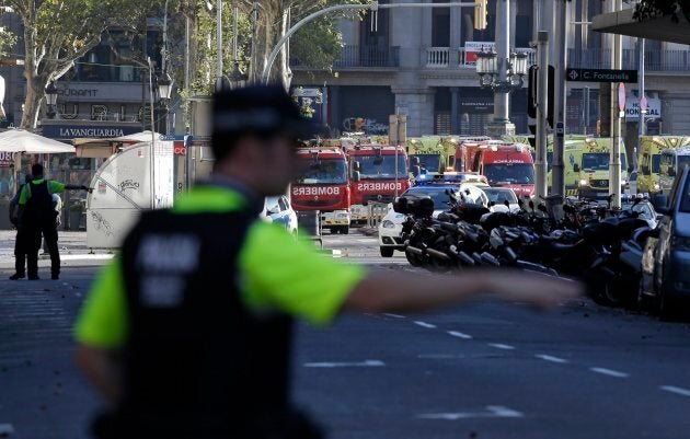 A police officer gestures as he blocks a street in Barcelona on Thursday.