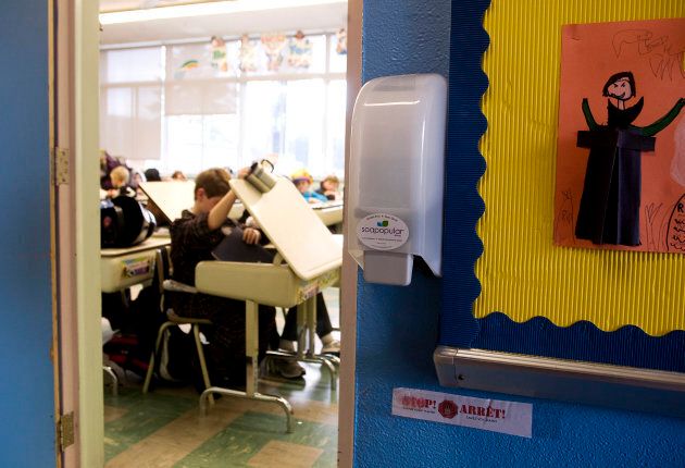 Hand sanitizer dispensers are installed outside classrooms as an extra precaution against the H1N1 virus in Lester B. Pearson School Board's elementary schools in Montreal, Oct. 29, 2009.