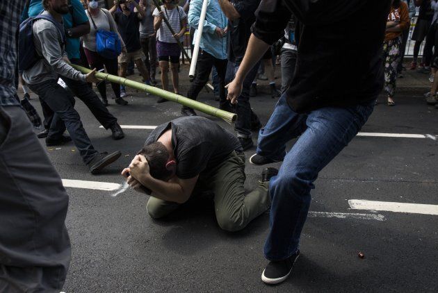 Counter protestors beat a white nationalist during clashes at Emancipation Park where the White Nationalists are protesting the removal of the Robert E. Lee monument in Charlottesville, Va., U.S. on August 12, 2017.