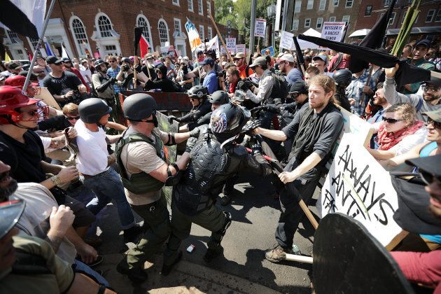 White nationalists, neo-Nazis and members of the alt-right clash with counter-protesters as they enter Lee Park during the "Unite the Right" rally August 12, 2017 in Charlottesville, Va.