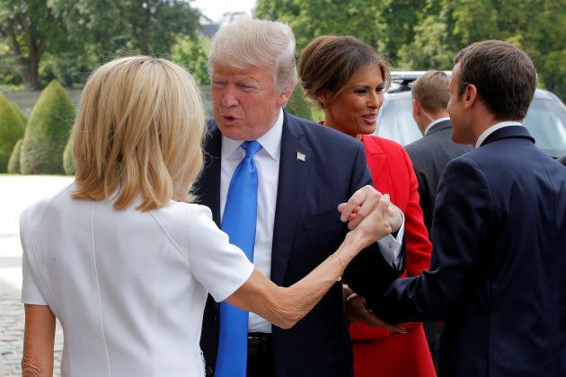 French President Emmanuel Macron (R) greets U.S First Lady Melania Trump while his wife Brigitte Macron (L) welcomes U.S. President Donald Trump at Les Invalides museum in Paris, France, July 13, 2017. REUTERS/Michel Euler/Pool
