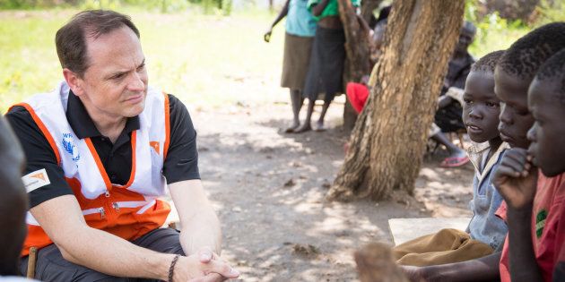 World Vision President Michael Messenger listens to the stories of refugee families.