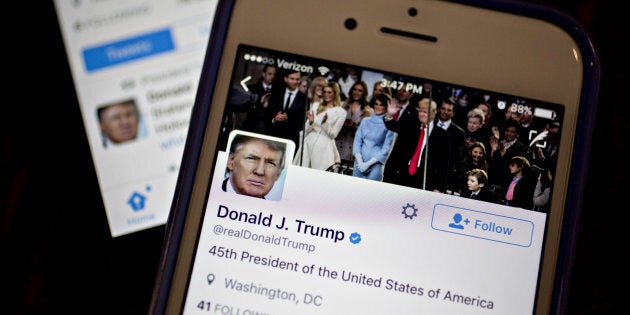 The Twitter Inc. accounts of U.S. President Donald Trump, @POTUS and @realDoanldTrump, are seen on an Apple Inc. iPhone.