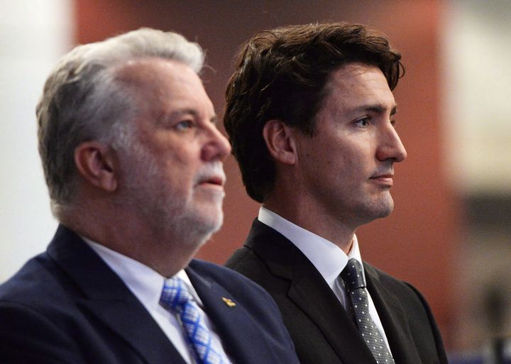 Quebec Premier Philippe Couillard and Prime Minister Justin Trudeau attend a funeral service at Quebec City convention centre for three of the six victims of the Quebec City mosque shooting Friday, Feb. 3, 2017.