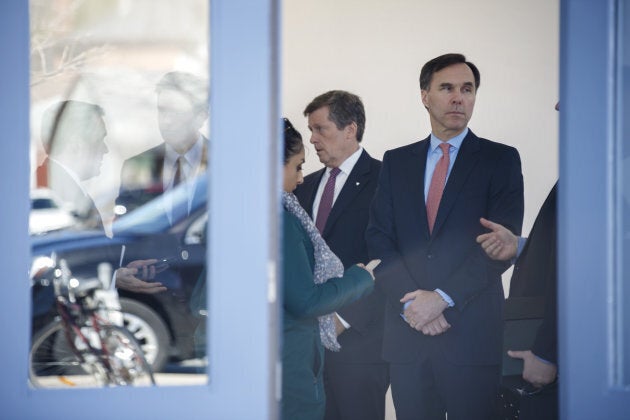 Bill Morneau, Canada's finance minister, right, stands after a meeting in Toronto, Ont. on April 18, 2017.