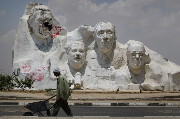 A vandalized statue of former Egyptian President Hosni Mubarak (left) dominates other sculptures of Egyptian Nobel Prize winners on a road to Cairo on May 29, 2011.