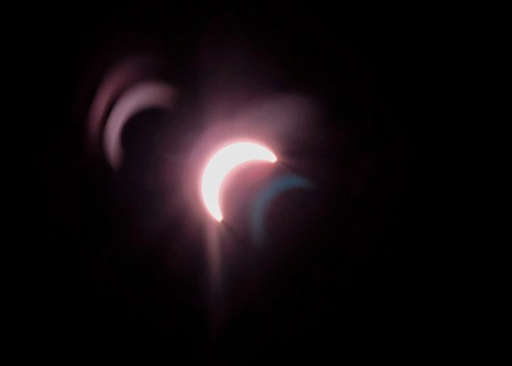 Lens flare creates ghost images in this view of a partial solar eclipse from the Spark Science Centre in Calgary, on Aug. 21, 2017.
