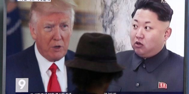 A man in Seoul, South Korea watches a TV screen showing U.S. President Donald Trump and North Korean leader Kim Jong Un on Aug. 10, 2017.