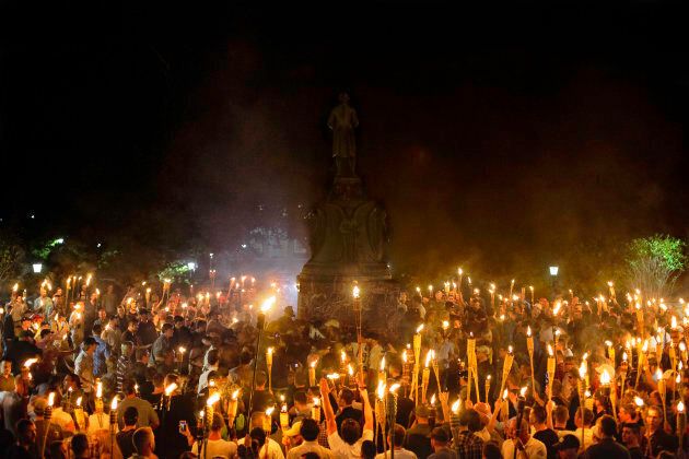 Neo-Nazis and white supremacists encircle counter protesters at the base of a statue of Thomas Jefferson after marching through the University of Virginia campus with torches in Charlottesville, Va., on Aug. 11, 2017.