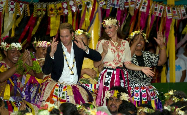 The Duke and Duchess of Cambridge dance with local ladies at a Vaiku Falekaupule Ceremony during the Royal couple's tour of the Far East in 2012 in Funafuti, Tuvalu. (Photo by Samir Hussein/WireImage)