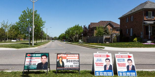 Open house signs are displayed on the side of a road in the Greater Toronto suburb of Brampton, Ontario, Saturday, May 20, 2017. The sharp reversal in Toronto's home prices has thrown Canada's biggest property market into chaos.