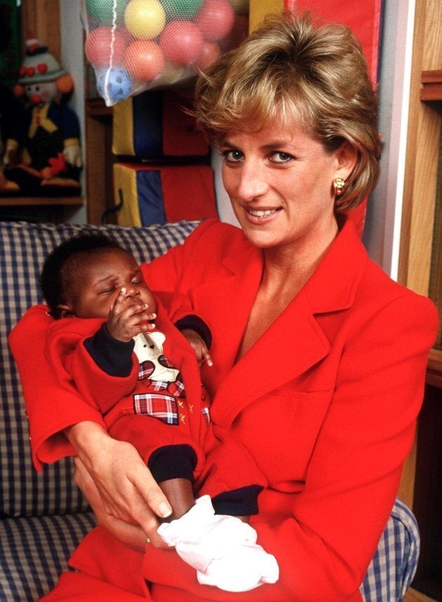 Princess Diana holding eight week old baby Tamara at the London Lighthouse, a centre for people affected by HIV and AIDS, in London, October 1996. (Photo by Jayne Fincher/Getty Images)