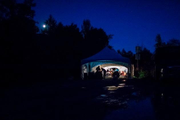 Refugees who crossed the Canada-U.S. border illegally near Hemmingford, Que. are processed in a tent after being arrested by the RCMP on Aug. 5, 2017.