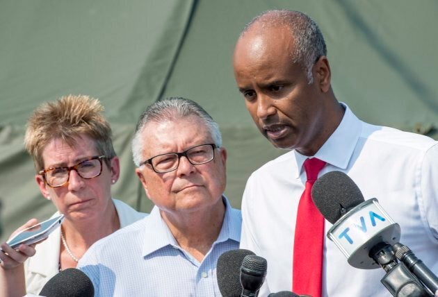 Immigration Minister Ahmed Hussen, right, Public Safety Minister Ralph Goodale and Quebec Liberal MP Brenda Shanahan speak to media on Aug. 21 2017 near Saint-Bernard-de-Lacolle, Que.