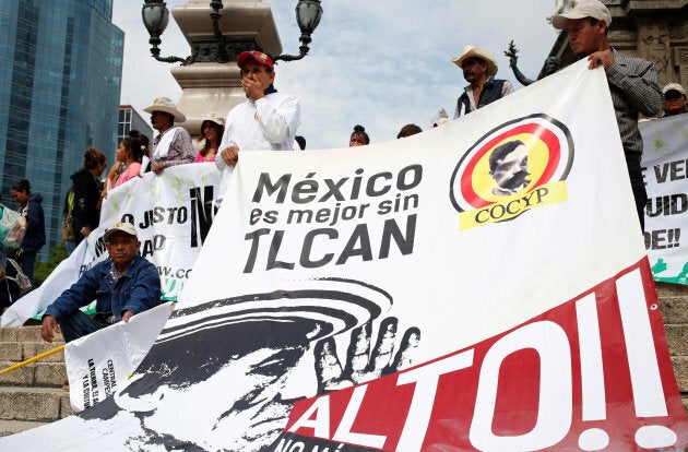 Farmers from different states, holding a banner, take part in a march against the North American Free Trade Agreement (NAFTA) talks in front of the Angel of Independence Monument in Mexico City, Mexico July 26, 2017. The banner reads "Mexico is better without NAFTA."