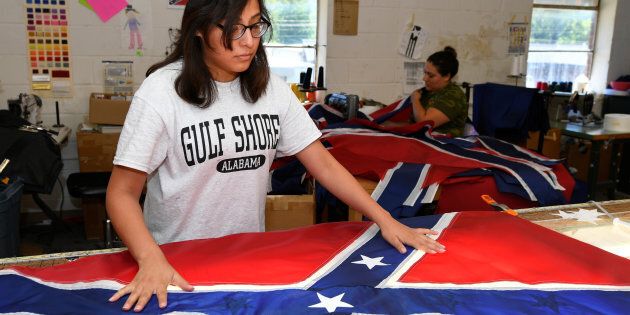 Cynthia Hernandez places stars on a Confederate Battle Flag in the Alabama Flag & Banner shop in Huntsville, Alabama, U.S., August 24, 2017.