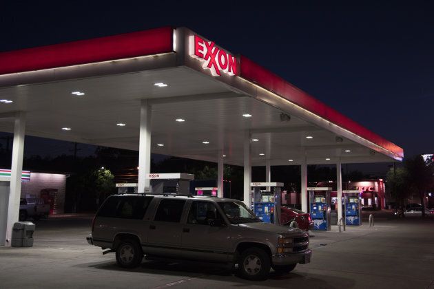 A vehicle exits an Exxon Mobil Corp. gas station at night in Dallas, Texas, on Monday, July. 24, 2017.