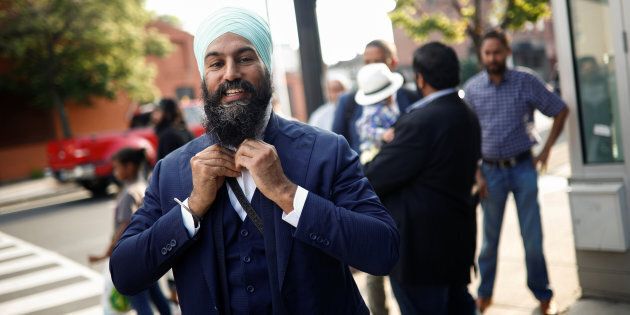 NDP leadership candidate Jagmeet Singh puts on his tie outside a meet and greet event in Hamilton, Ont. on July 17, 2017.