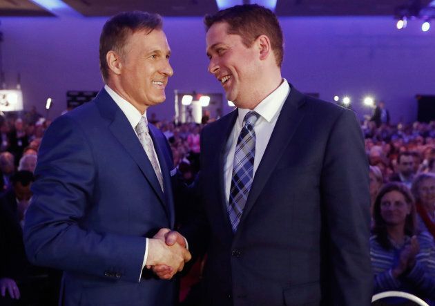 Maxime Bernier speaks with Andrew Scheer after the first results are announced during the Conservative Party of Canada leadership convention in Toronto on May 27, 2017.