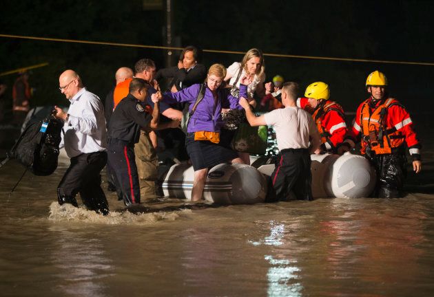 A dingy full of passengers that were stranded on a GO Train is rescued during a heavy rainstorm in Toronto on July 8, 2013.