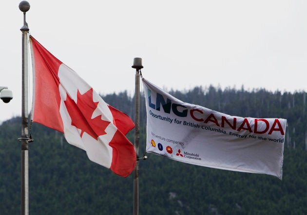 Canadian and LNG Canada flags fly outside of the company's office in Kitimat, B.C.