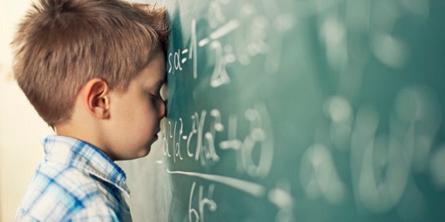 A little boy in math class overwhelmed by math.