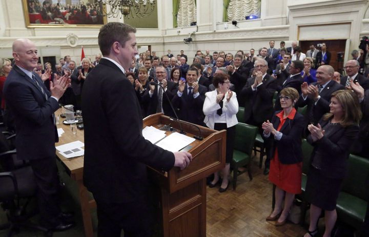 Newly-elected Conservative Party Leader Andrew Scheer receives a standing ovation from his Conservative caucus on Parliament Hill on May 29, 2017.