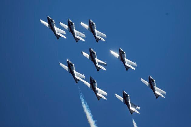 A CF Snowbirds fly-by roars through the sky during day one of the Canadian International Air Show in Marilyn Bell Park, Toronto, Ont.
