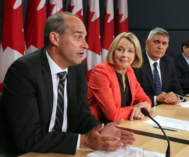 Guy Caron appears with NDP candidates Peggy Nash and Andrew Thomson at a news conference in Ottawa on Sept. 1, 2015.