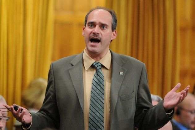 Guy Caron shows off his "Movember" moustache during question period on Nov. 21, 2011.