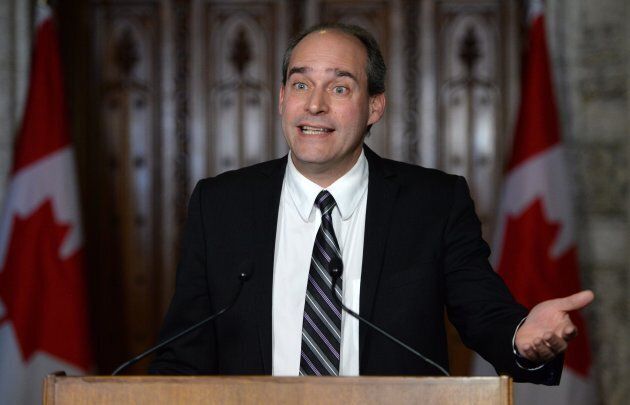 Guy Caron, then the deputy NDP finance critic, speaks at a news conference in front of the House of Commons on Jan. 26, 2015.
