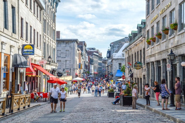 People walk around on the popular St. Paul street in Montreal's Old Port on June 6, 2015.